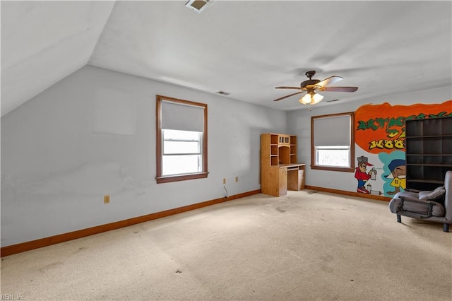 unfurnished room with carpet, visible vents, baseboards, and vaulted ceiling