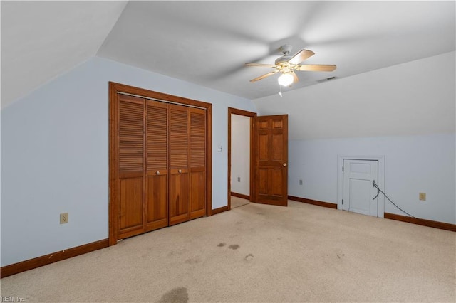 additional living space featuring light carpet, vaulted ceiling, and baseboards