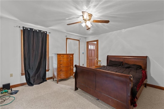 bedroom featuring light carpet, baseboards, and a ceiling fan