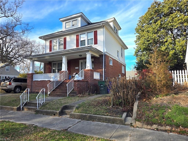 traditional style home with a porch and brick siding