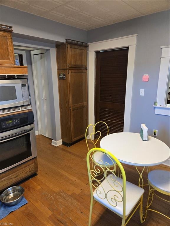 dining space with wood finished floors and baseboards