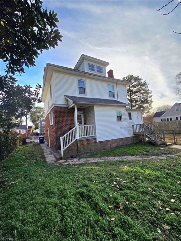 back of house featuring a yard and fence