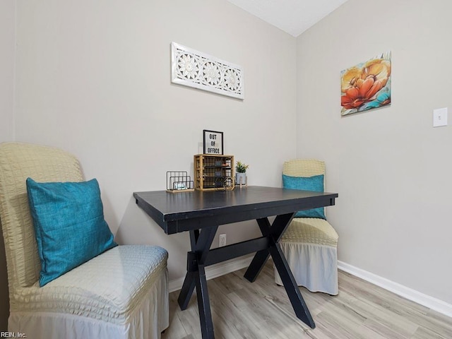 interior space with wood finished floors and baseboards