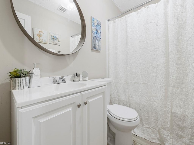 full bathroom featuring visible vents, vanity, and toilet