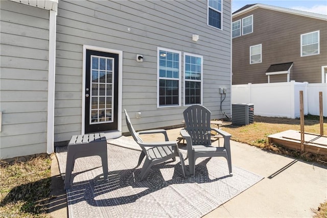 view of patio / terrace with central AC and fence