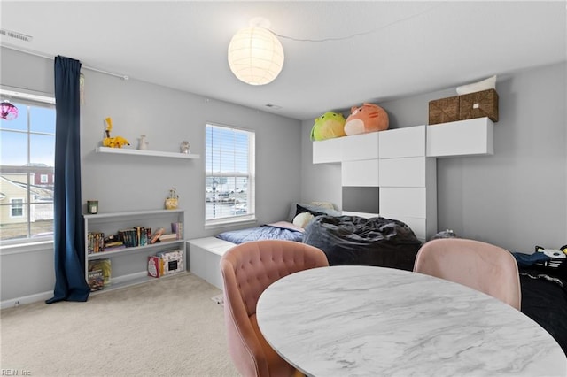 bedroom featuring baseboards, visible vents, and light colored carpet