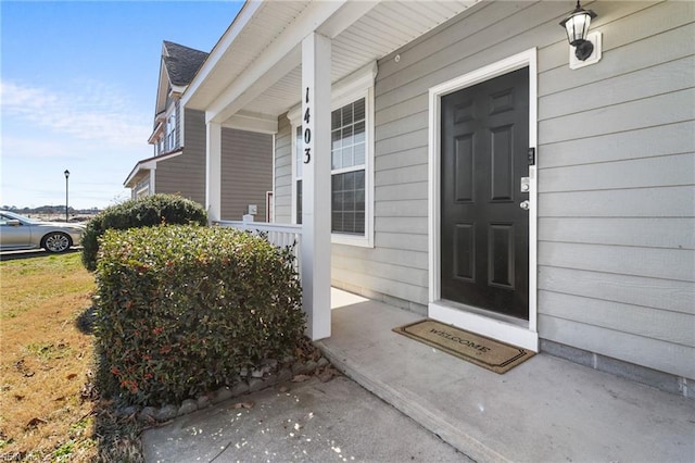 view of exterior entry with covered porch