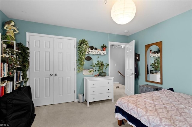 bedroom with light carpet and a closet