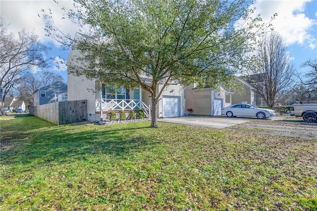 view of front of house featuring covered porch, concrete driveway, a front lawn, and fence