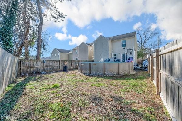 view of yard with a fenced backyard and a fenced in pool