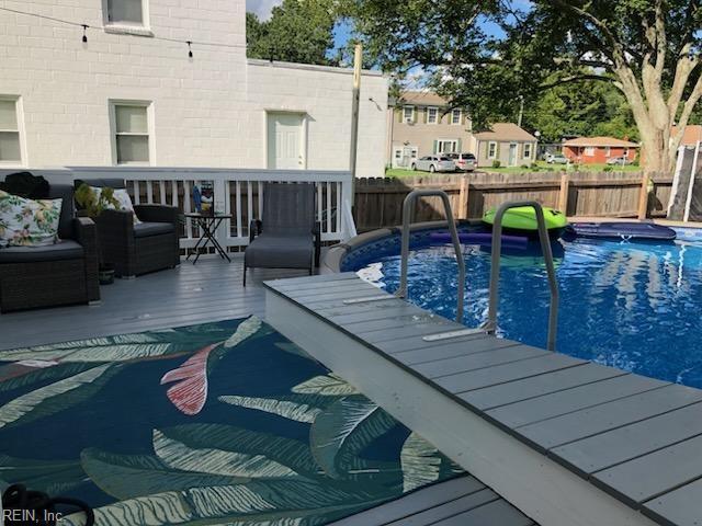 view of pool featuring a fenced in pool, fence, and a deck