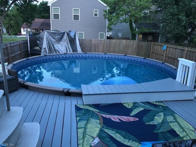 view of pool featuring a fenced backyard, a deck, and a fenced in pool