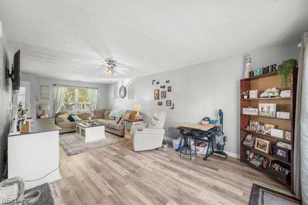 living area with ceiling fan and light wood-style flooring