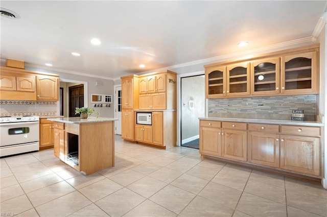 kitchen featuring white appliances, visible vents, a kitchen island, glass insert cabinets, and light countertops