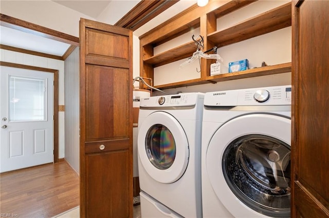 laundry room with light wood-type flooring, laundry area, and separate washer and dryer