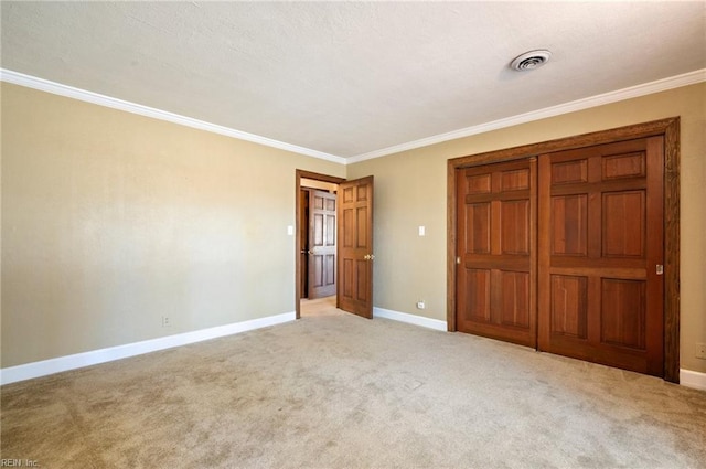 unfurnished bedroom featuring visible vents, baseboards, light colored carpet, and ornamental molding