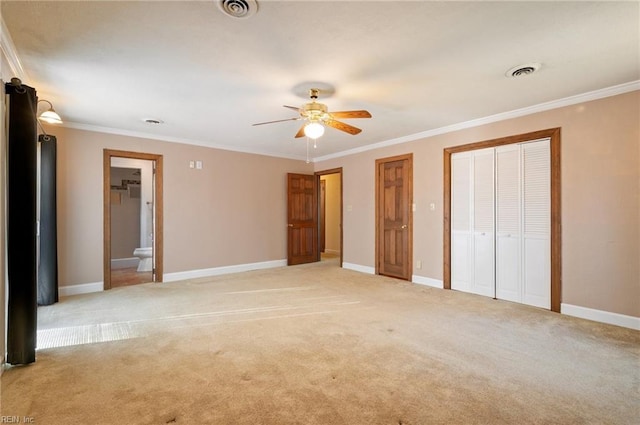 unfurnished bedroom with ornamental molding, visible vents, and baseboards