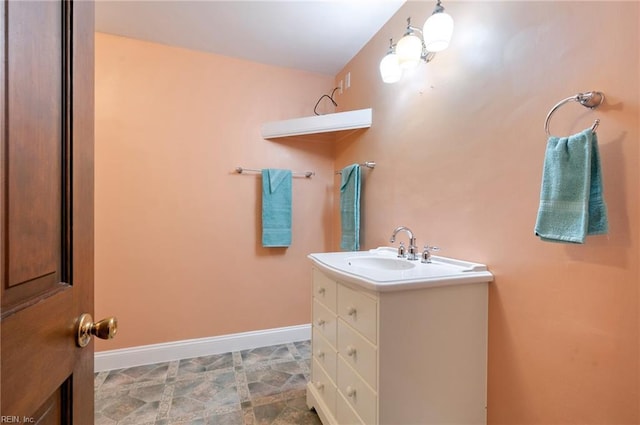 bathroom with baseboards and vanity