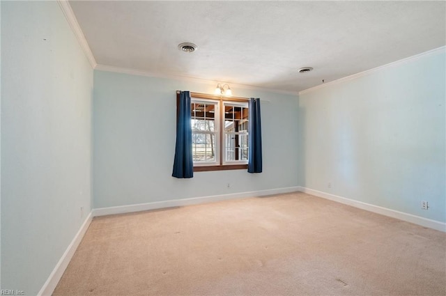 spare room with light carpet, ornamental molding, and baseboards