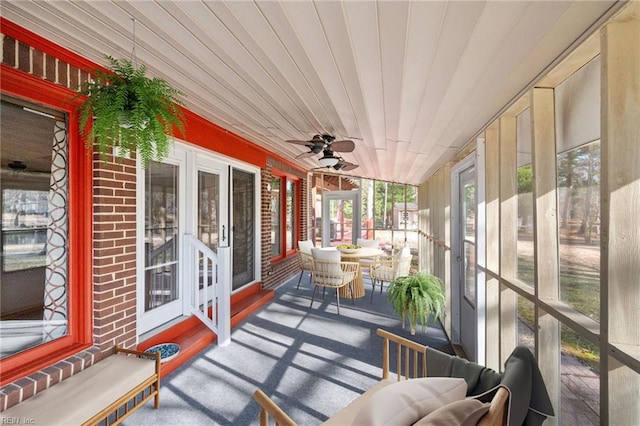 sunroom with wood ceiling and ceiling fan