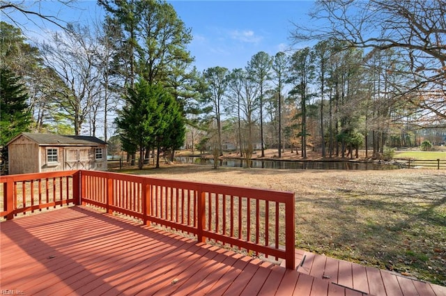 wooden deck featuring an outbuilding, a storage shed, and a lawn