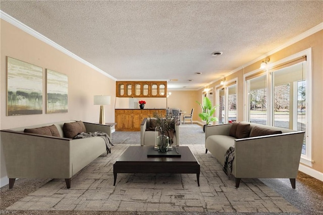 living room featuring a textured ceiling, visible vents, crown molding, and light colored carpet