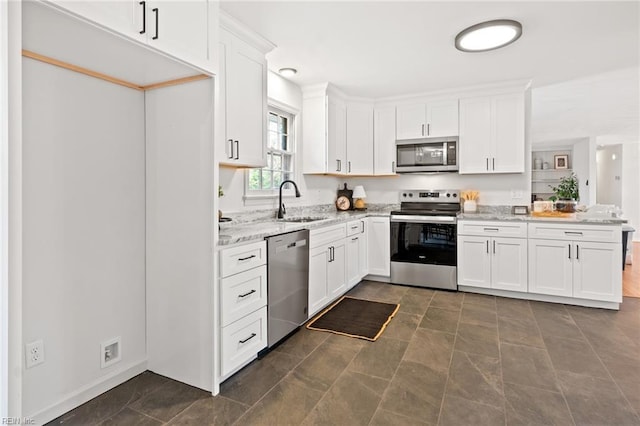 kitchen featuring light stone countertops, white cabinetry, and appliances with stainless steel finishes