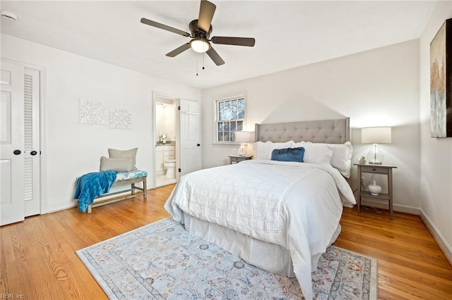 bedroom featuring ensuite bathroom, wood finished floors, a ceiling fan, and baseboards