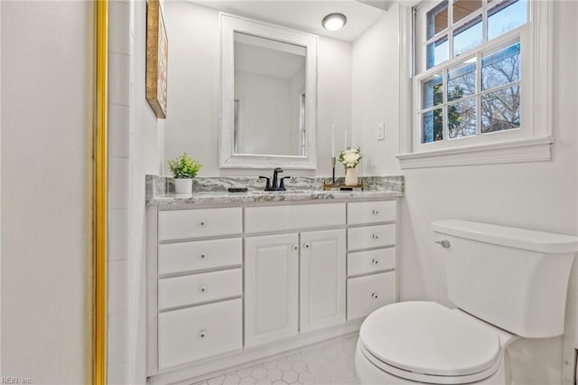 full bath featuring toilet and vanity