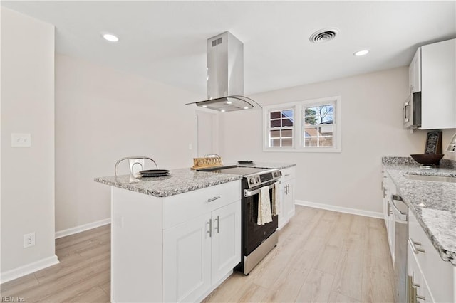 kitchen with white cabinetry, island range hood, stainless steel appliances, and light stone counters