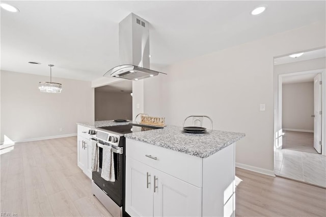 kitchen with white cabinets, hanging light fixtures, stainless steel electric range, light stone countertops, and island exhaust hood