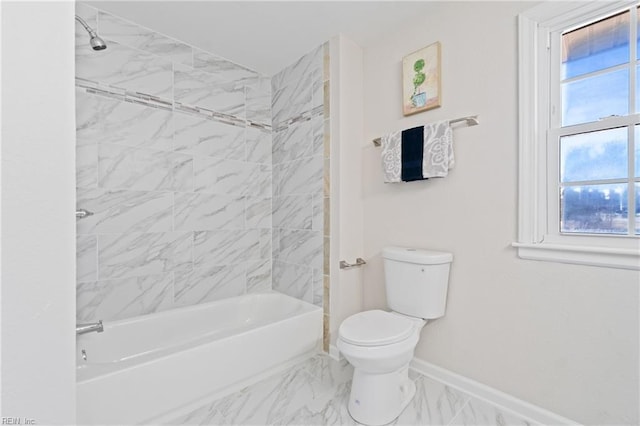 bathroom featuring marble finish floor, shower / bathing tub combination, toilet, and baseboards