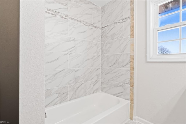 full bath featuring baseboards and shower / bathing tub combination