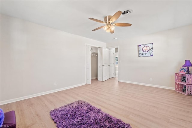 bedroom featuring light wood finished floors, visible vents, and baseboards