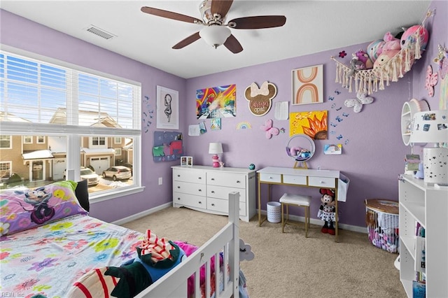 carpeted bedroom with visible vents, baseboards, and a ceiling fan