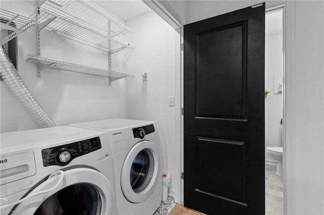 washroom with laundry area and washer and dryer