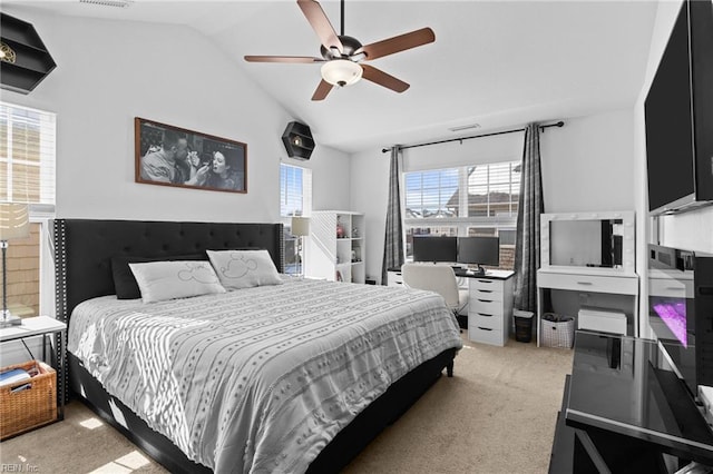 bedroom with a ceiling fan, vaulted ceiling, light colored carpet, and visible vents