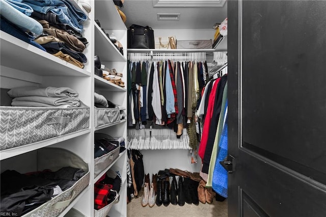 walk in closet with visible vents and carpet floors