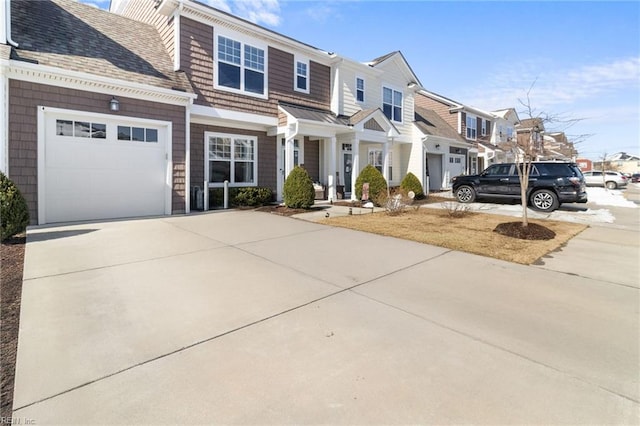 view of front of house with a residential view, driveway, a garage, and roof with shingles