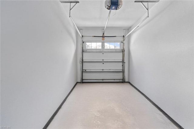 garage with a garage door opener and baseboards