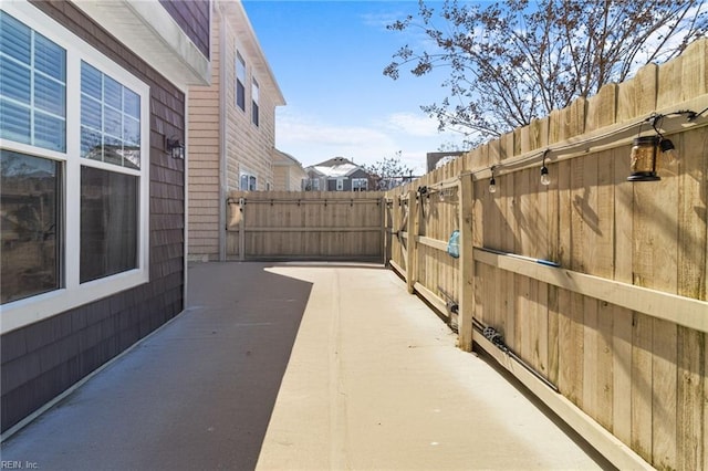 view of patio featuring a gate and fence