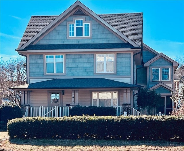 view of front of property featuring covered porch and roof with shingles