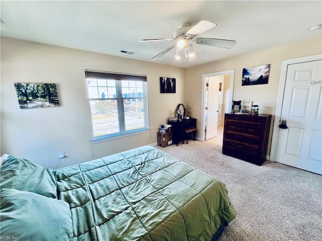 bedroom with carpet, visible vents, and ceiling fan