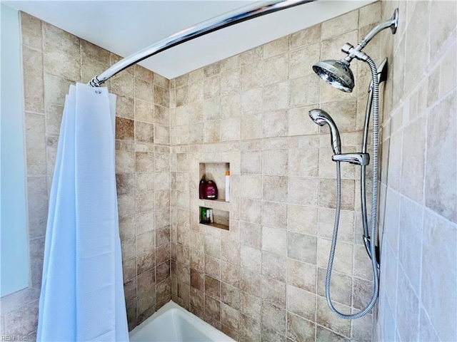 bathroom with tiled shower