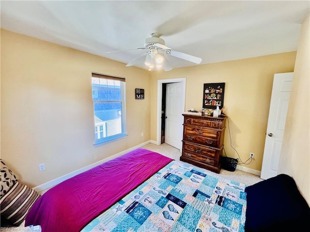 carpeted bedroom featuring ceiling fan and baseboards