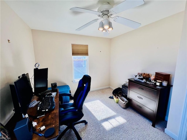 carpeted home office featuring ceiling fan and baseboards