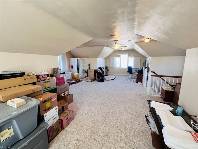 interior space featuring carpet floors, vaulted ceiling, and baseboards