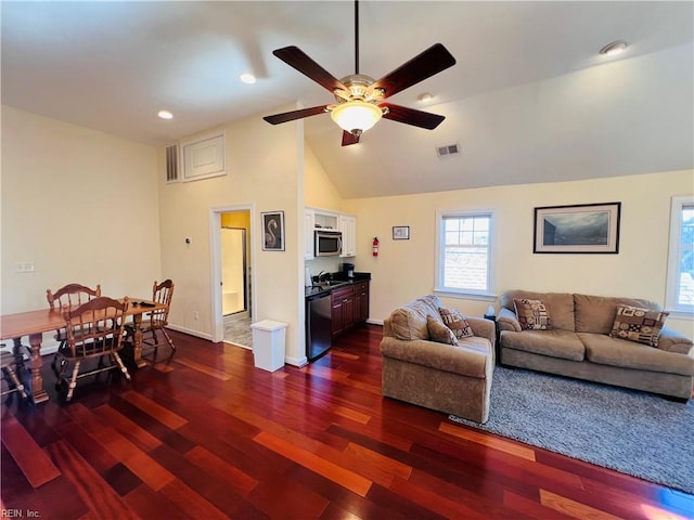 living room featuring dark wood-style floors, visible vents, vaulted ceiling, ceiling fan, and baseboards