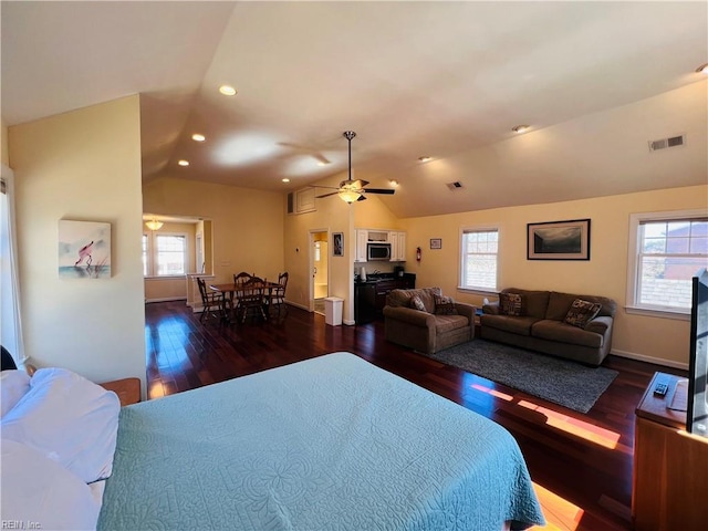 bedroom featuring lofted ceiling, recessed lighting, wood finished floors, visible vents, and baseboards