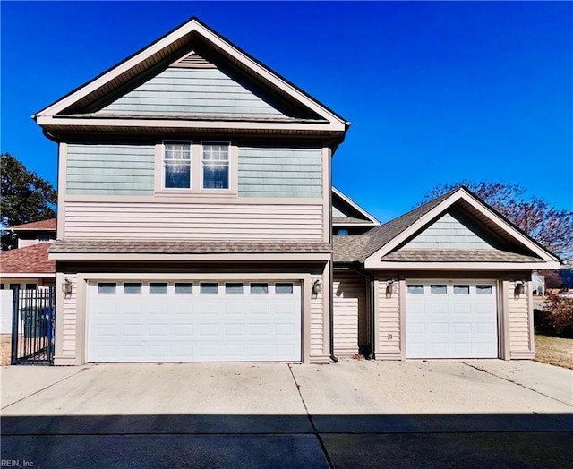 traditional-style house with a garage and concrete driveway